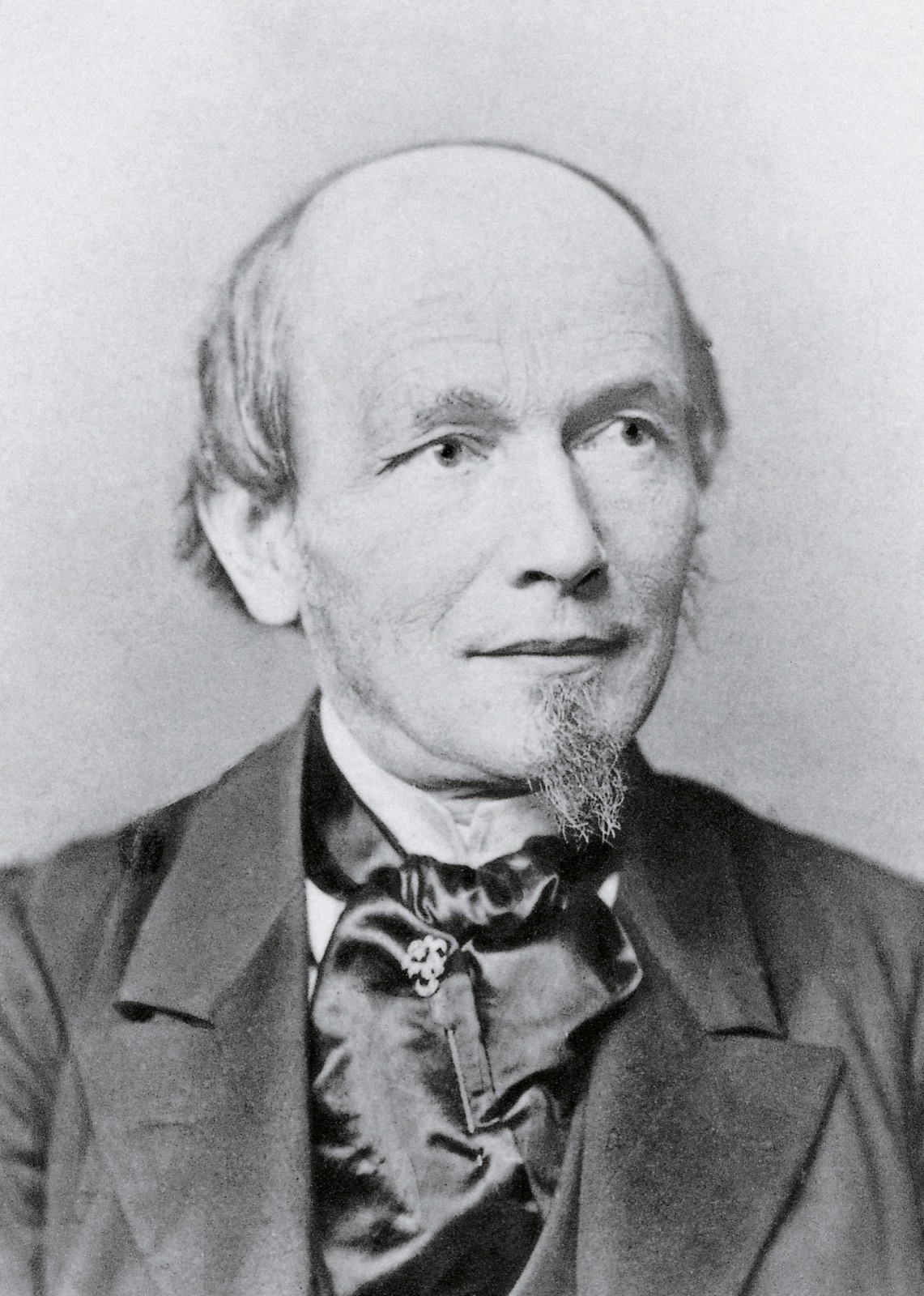 A portrait engraving of Ferdinand Adolph Lange, a serious bearded man in mid-nineteenth-century dress