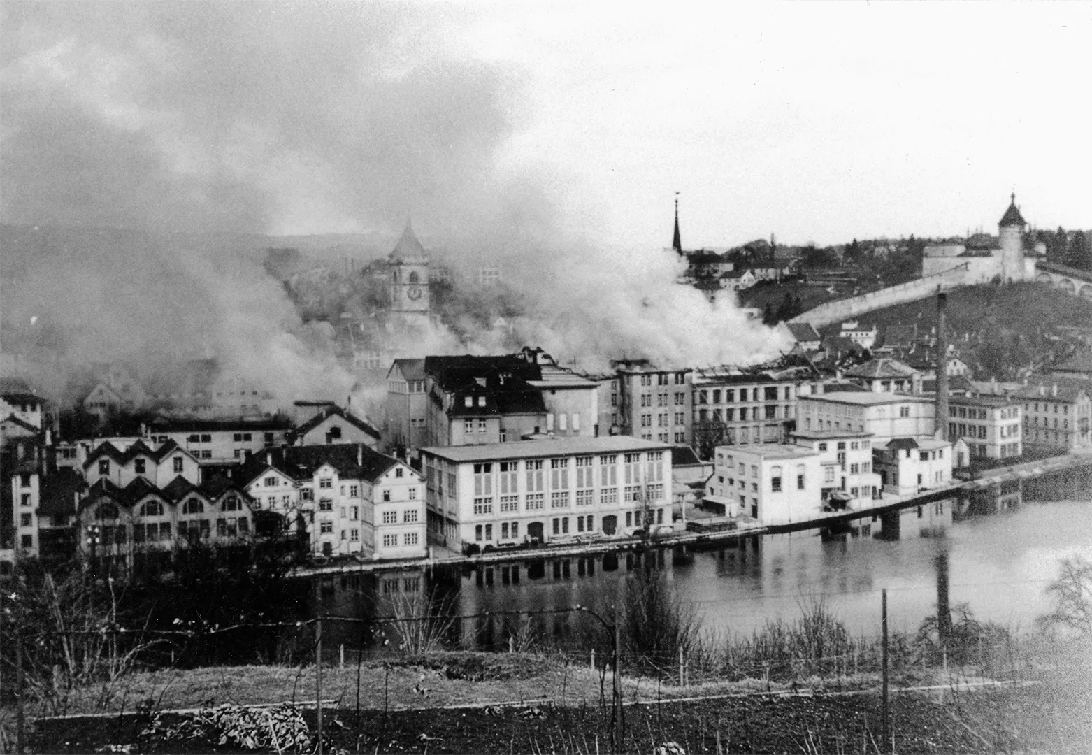 An archival photograph of Schaffhausen after the American bombing raid of 1 April 1944, damaged buildings near the IWC factory by the Rhine